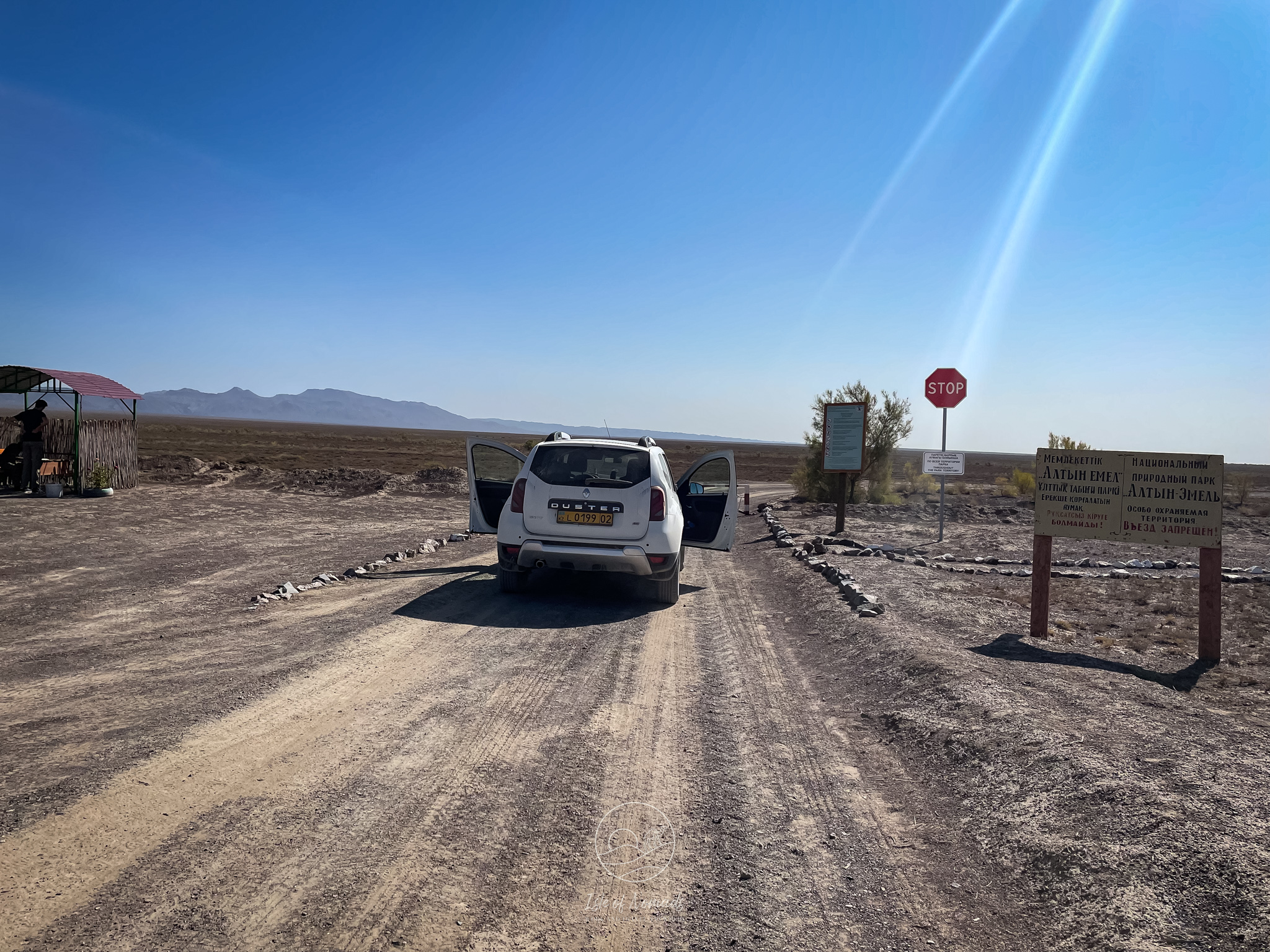 A picture of our car parked in front of the checkpoint on the way to the Aktau mountains